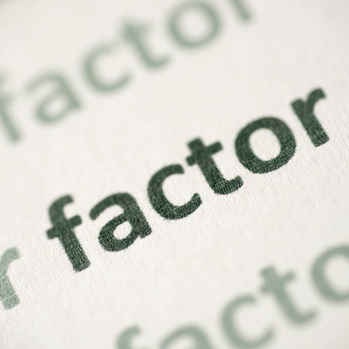 Photo of the word factor on a printed page zoomed in close up