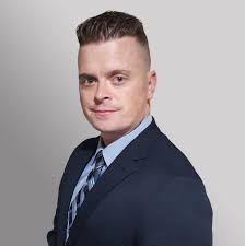 Robbie Franklin, real estate specialist at WeBuyHouses.com Virginia, wearing a dark suit and tie. Contact Robbie for professional guidance on foreclosure prevention options and solutions for homeowners facing financial challenges.