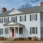 Two-story white colonial house with red door and black shutters in Virginia